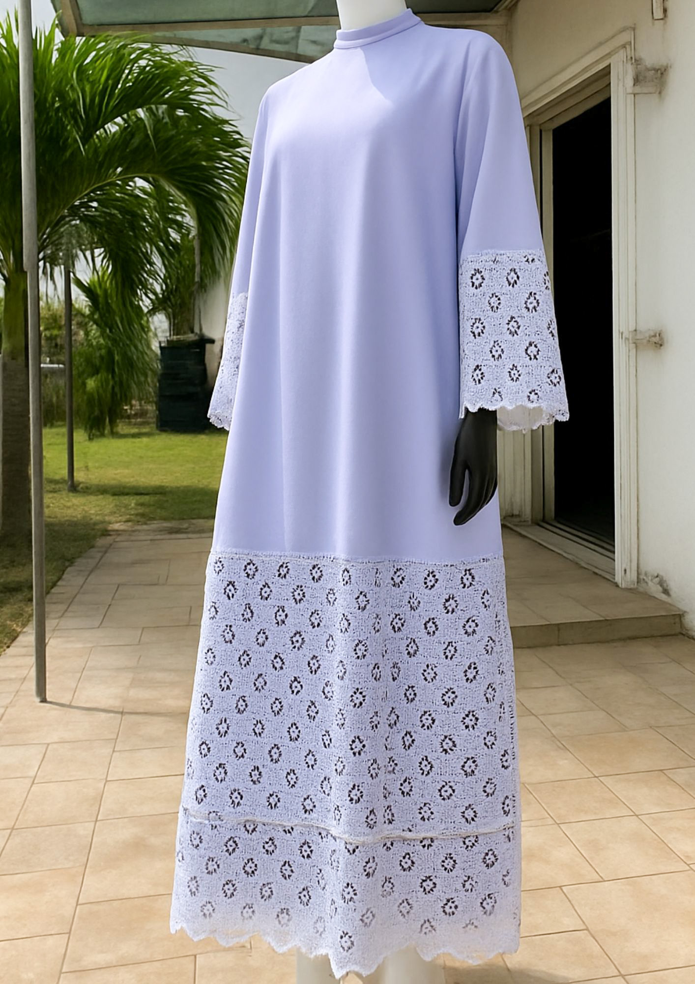 White lavender abaya features intricate white lace details on the cuffs and hem.
