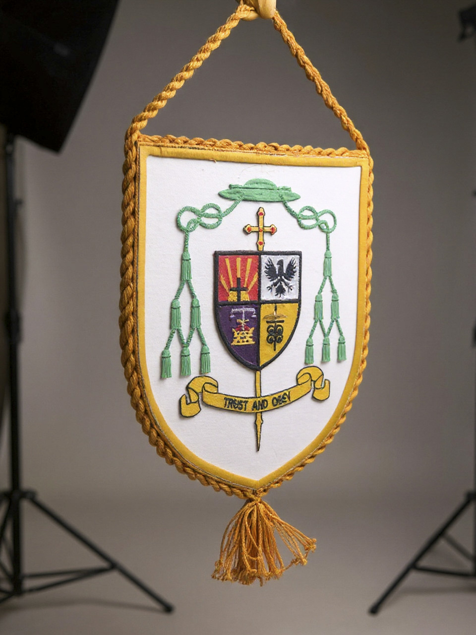 Decorative liturgical banner featuring the personalized coat of arms of a Catholic bishop.