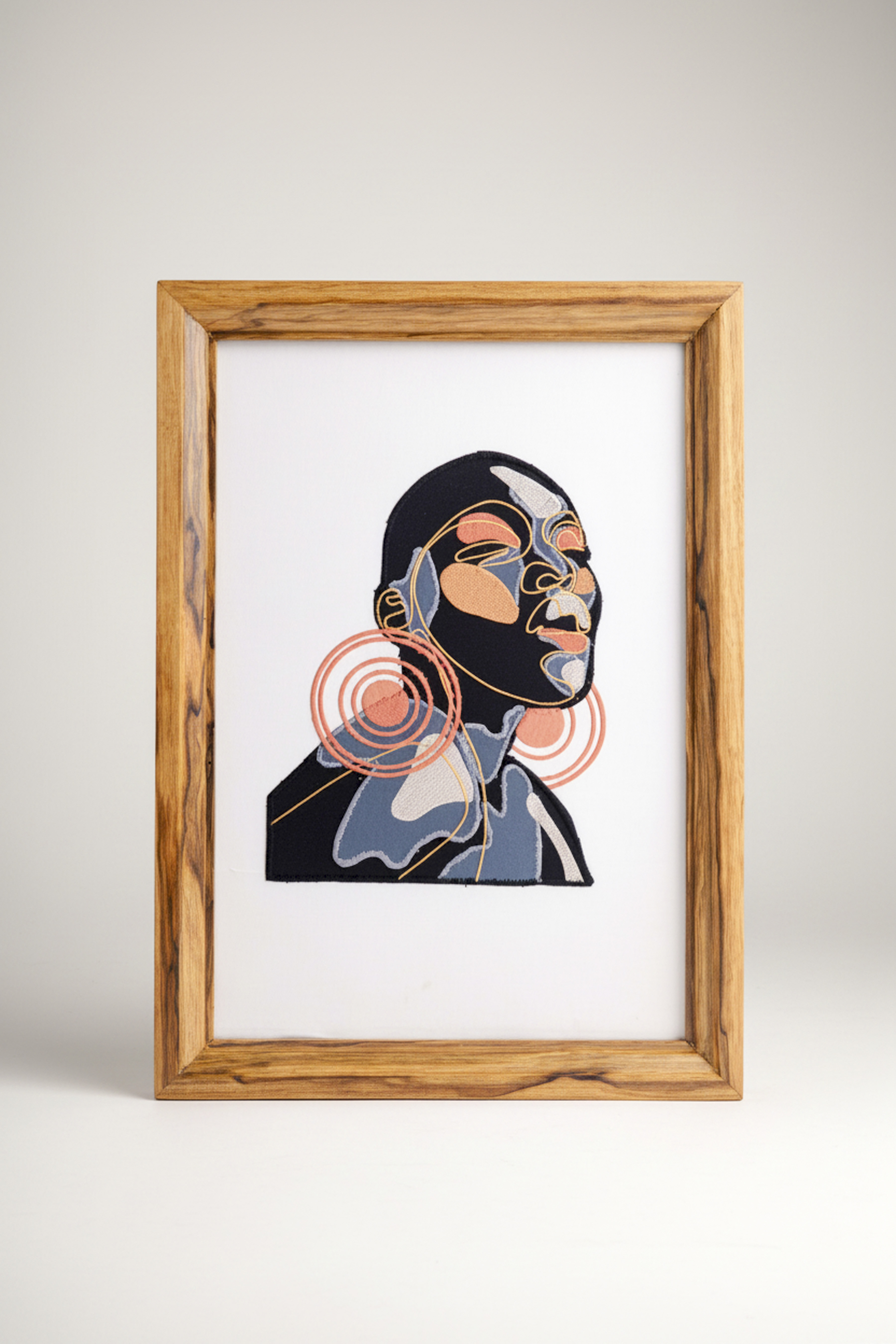  'Lira' print by featuring a stylized portrait with vibrant coral-colored circular earrings. 