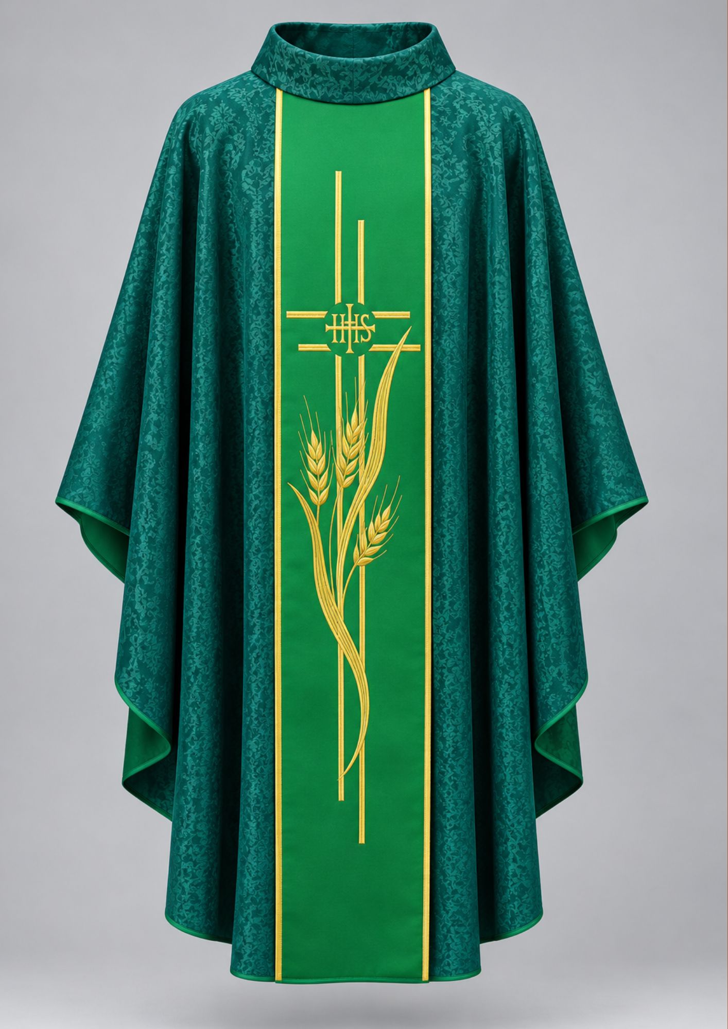 Green Gothic-style liturgical chasuble features a damask patterned fabric and a central embroidered gold orphrey band with wheat stalks and the IHS monogram.